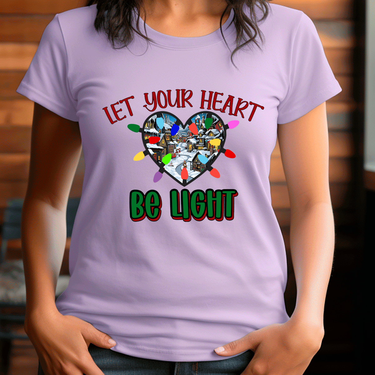 Person wearing a purple t-shirt with a heart-shaped design and text 'Let your heart be light'.