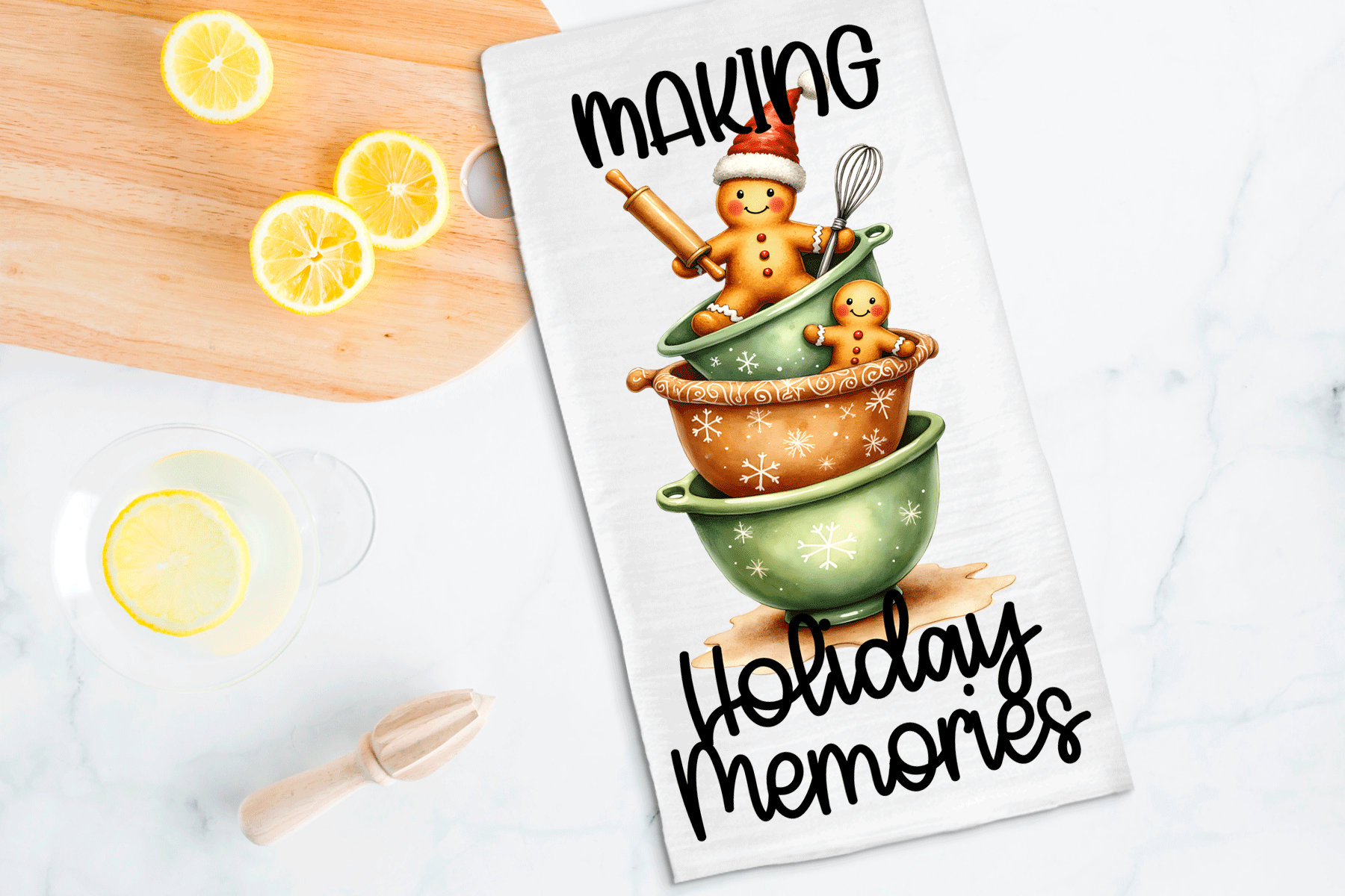Tea towel with gingerbread man design and text 'Making Holiday Memories' on a kitchen counter with lemons.