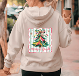 Person wearing a hoodie with a Christmas tree design and 'Merry & Bright' text.