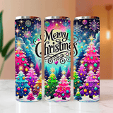 Three colorful tumblers with Christmas tree designs and 'Merry Christmas' text on a blurred background.