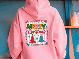 Pink hoodie with 'Merry Christmas' design on a blue wall background