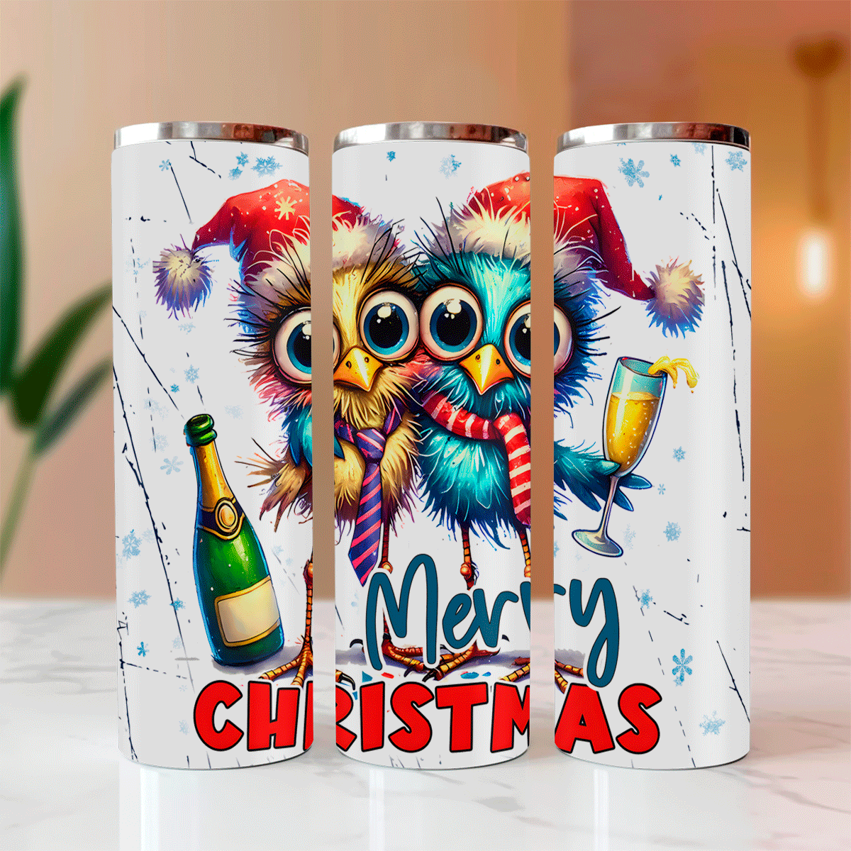 Three Christmas-themed tumblers with colorful owls and festive elements on a marble surface.