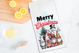 Christmas-themed towel with gnomes and snowman on a kitchen counter with lemons.