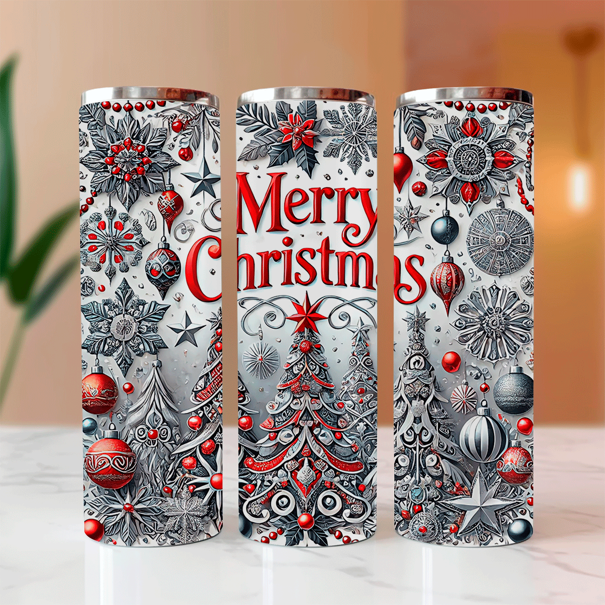 Three Christmas-themed tumblers with decorative patterns on a blurred background