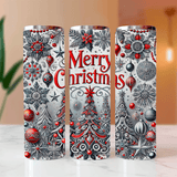 Three Christmas-themed tumblers with decorative patterns on a blurred background