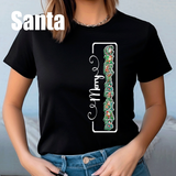 Person wearing a black t-shirt with a festive design and text.