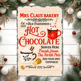 Advertisement for Mrs. Claus' Bakery hot chocolate with Christmas decorations.