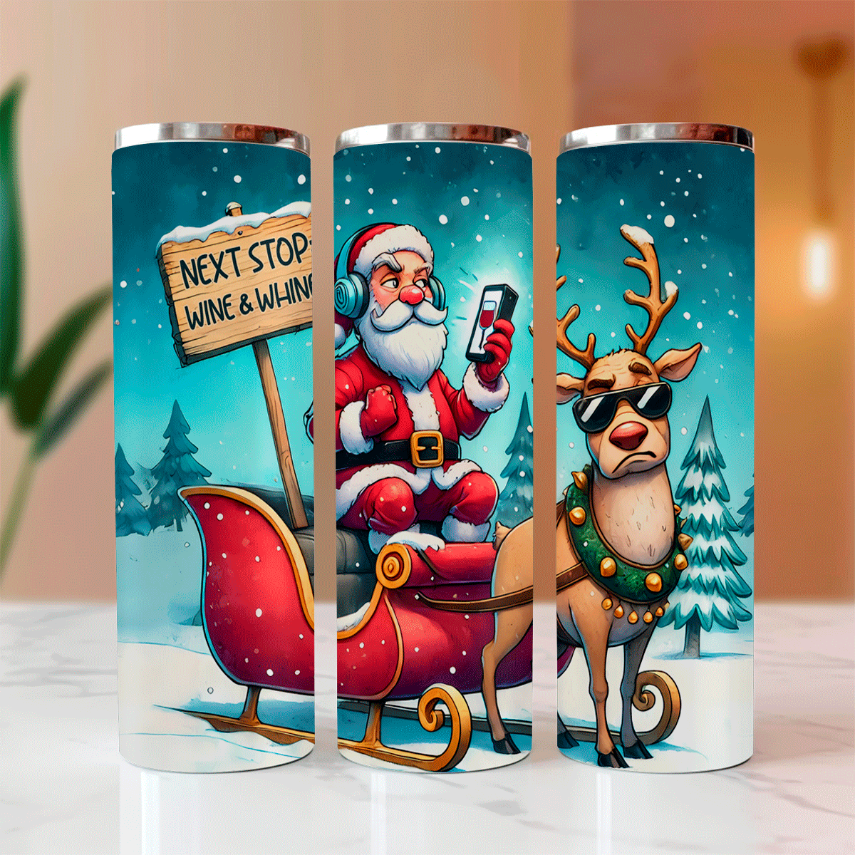 Three tumblers with Christmas-themed designs featuring Santa, a reindeer, and a sign.