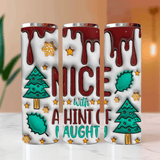 Three stainless steel tumblers with Christmas-themed designs on a marble surface.