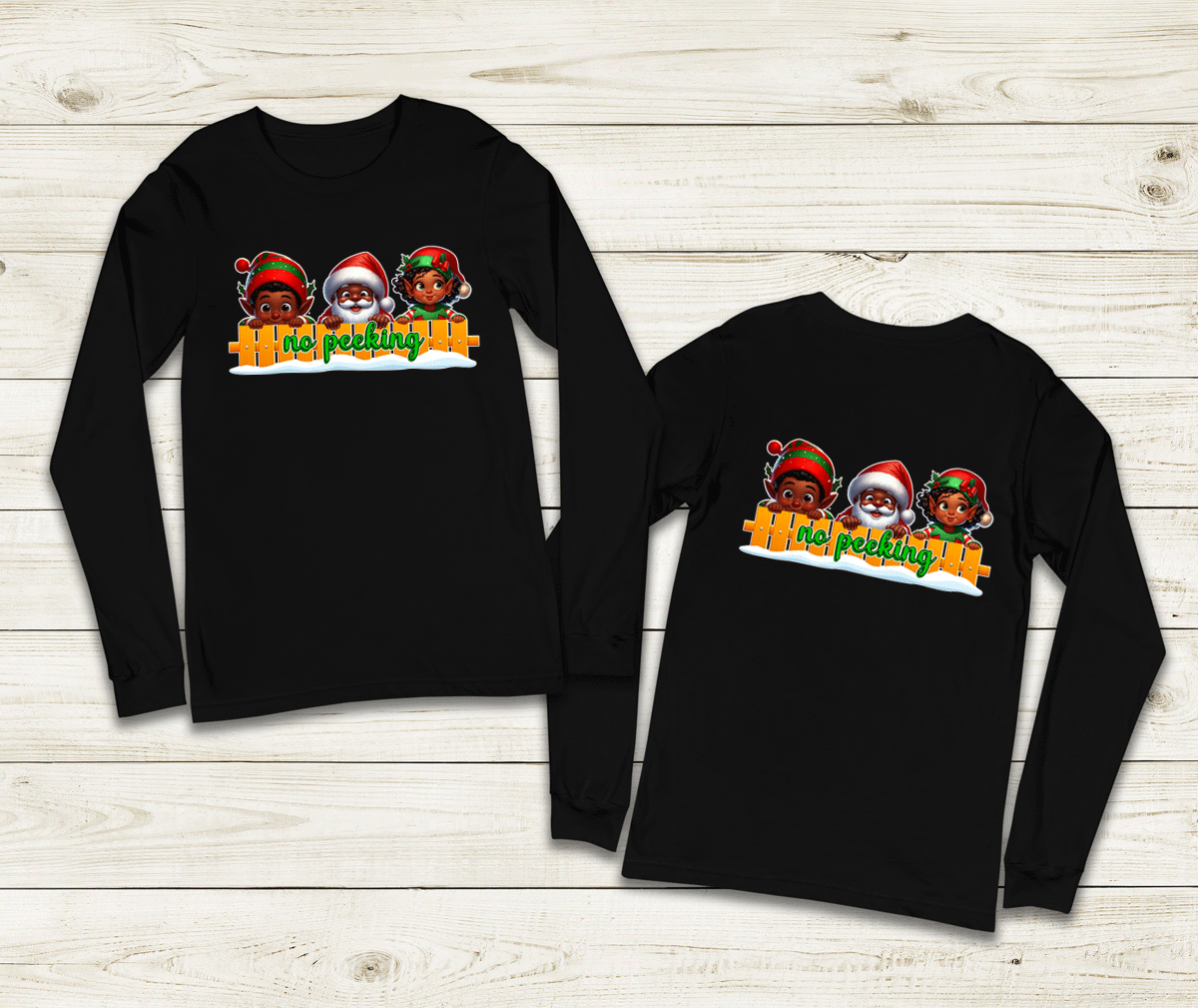 Two black long-sleeve shirts with a graphic design on a wooden surface