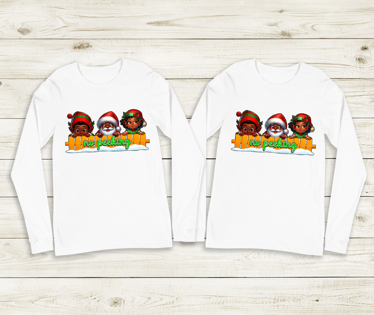Two white long-sleeve shirts with festive designs on a wooden surface