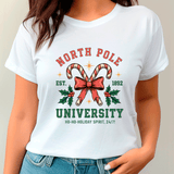 White t-shirt with 'North Pole University' design featuring candy canes and a bow.