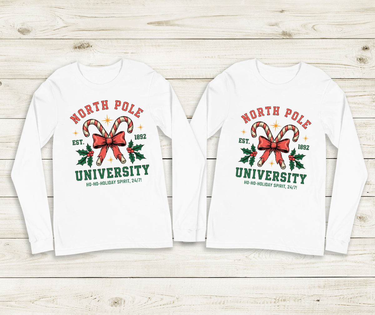 Two white long-sleeve shirts with 'North Pole University' design on a wooden surface