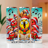 Three colorful tumblers with cartoon birds in Christmas hats and scarves on a light surface.