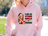 Person wearing a pink hoodie with a graphic design and text outdoors.