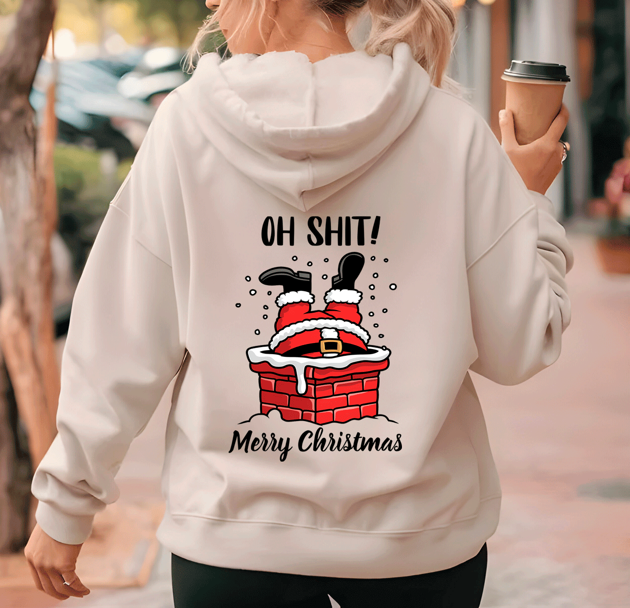 Person wearing a hoodie with a Christmas-themed graphic and text.