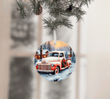 Decorative Christmas ornament with a vintage truck in a snowy scene, hanging from a tree.