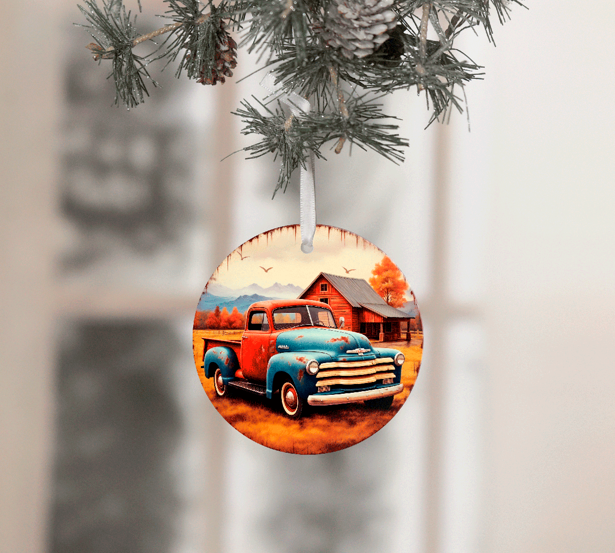 Circular Christmas ornament with a vintage truck design hanging from a tree branch.