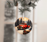 Christmas ornament with a red truck design hanging from a tree.