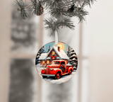 Christmas ornament with a red truck and cabin design, hanging from a tree.