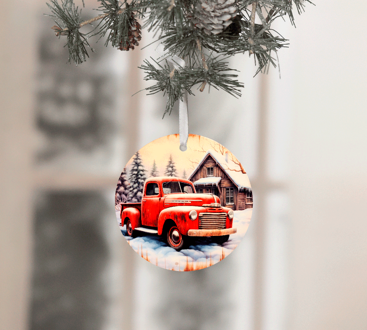 Decorative Christmas ornament with a red truck and cabin design, hanging from a tree.