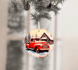 Decorative Christmas ornament with a red truck and cabin design, hanging from a tree.