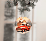 Christmas ornament with a red truck and cabin design, hanging from a tree.