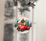 Christmas ornament with a red truck and cabin design, hanging on a tree branch.