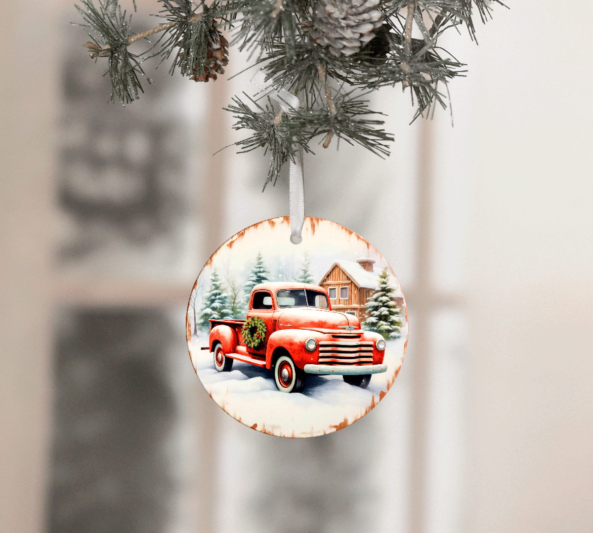 Decorative Christmas ornament with a red truck and pine trees on a white background
