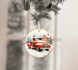 Decorative Christmas ornament with a red truck and pine trees on a white background