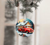 Christmas ornament with a red truck and cabin design, hanging from a tree.