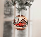 Christmas ornament with a red truck and cabin design, hanging from a tree branch.