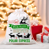 Personalized Christmas gift bag with reindeer design and text in front of a decorated Christmas tree.