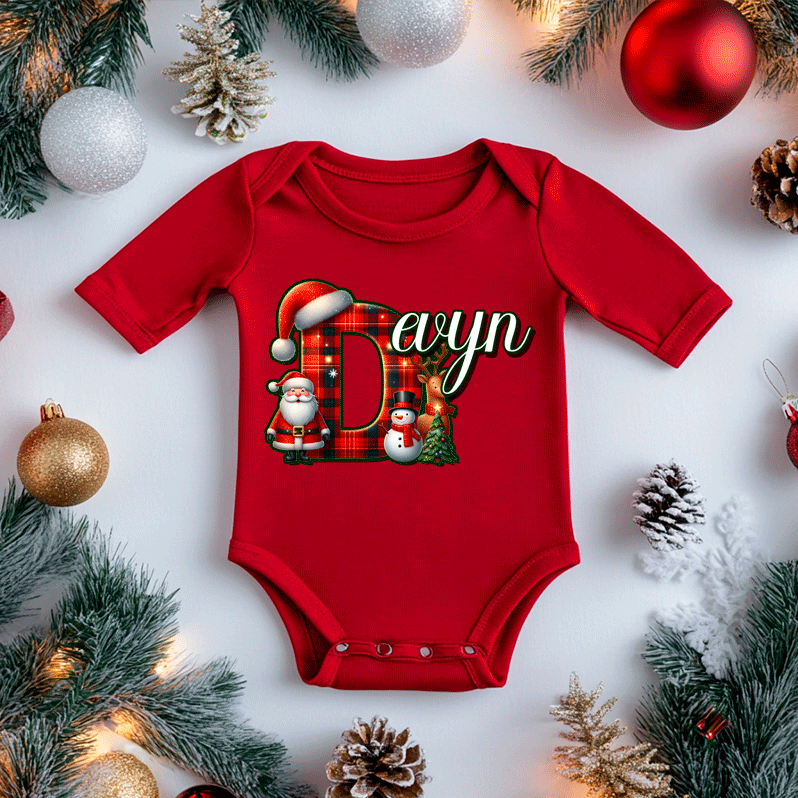 Red baby onesie with Christmas-themed design on a white background with festive decorations.