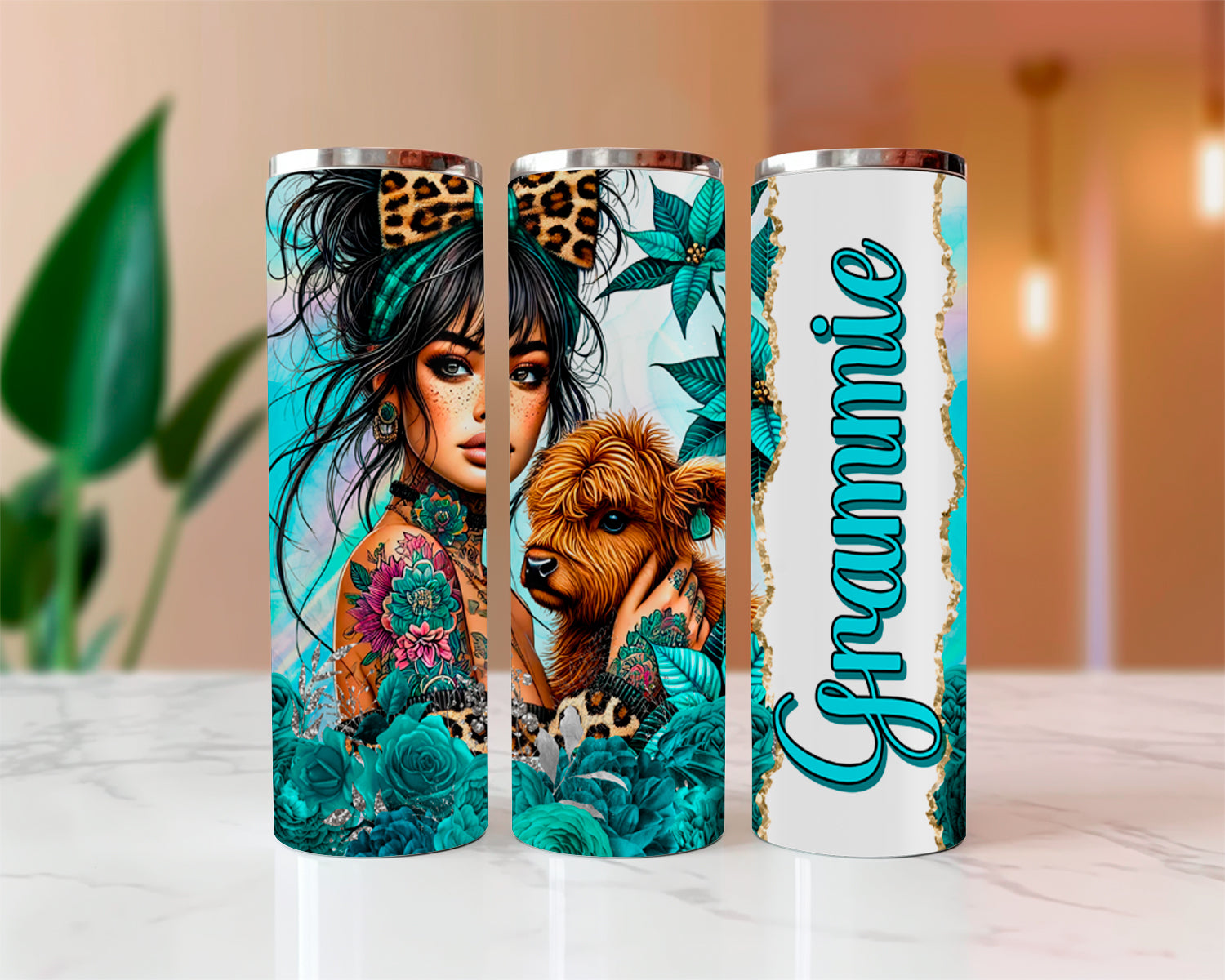 Three tumblers with artistic designs and 'Grammie' text on a blurred indoor background