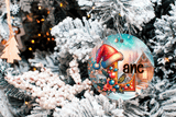 Decorative Christmas ornament with a colorful design on a snow-covered tree.