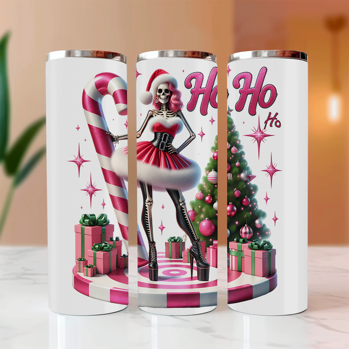 Three white tumblers with Christmas-themed designs featuring skeletons, candy canes, and trees.