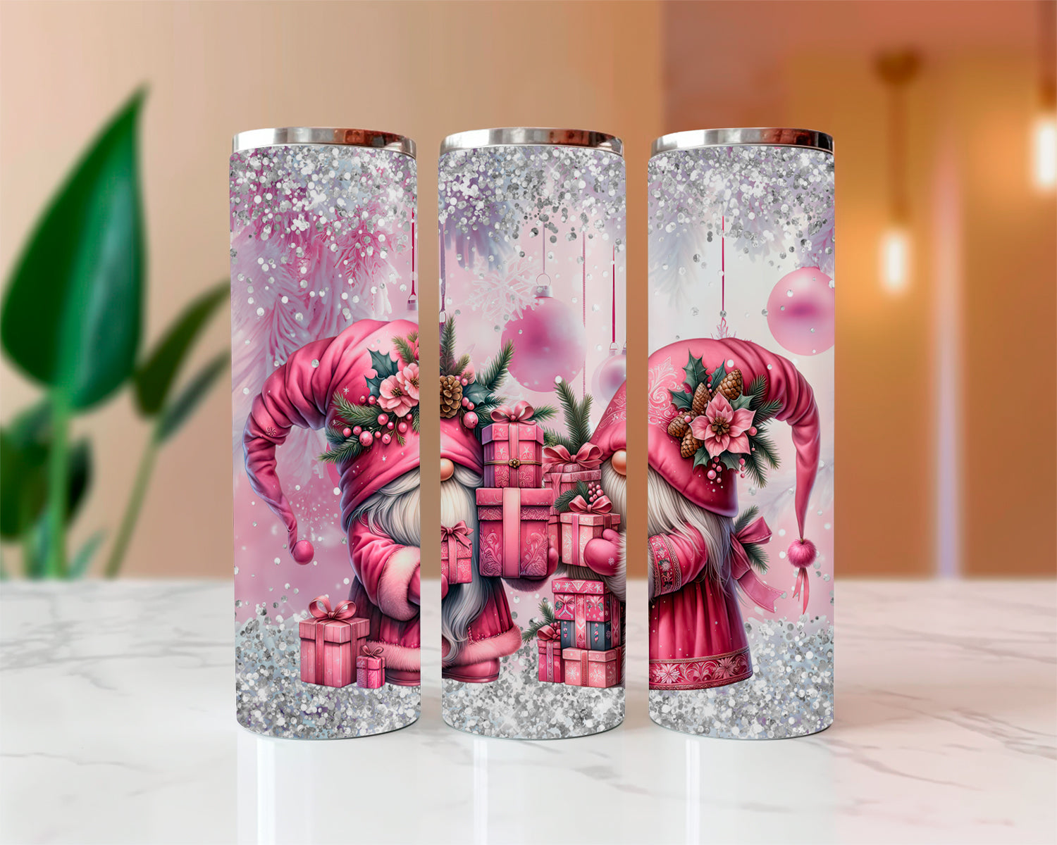 Three glittery tumblers with pink gnome design on a marble surface.
