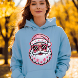 Person wearing a light blue hoodie with a colorful Santa Claus design outdoors.