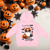 Pink hoodie with Halloween-themed design and text, surrounded by pumpkins and spider webs.