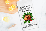 Tea towel with cookie graphic and text on a kitchen counter with lemons
