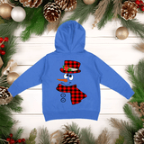 Blue hoodie with a snowman design on a wooden background with Christmas decorations