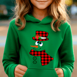 Child wearing a green hoodie with a snowman design featuring a red plaid hat and scarf.