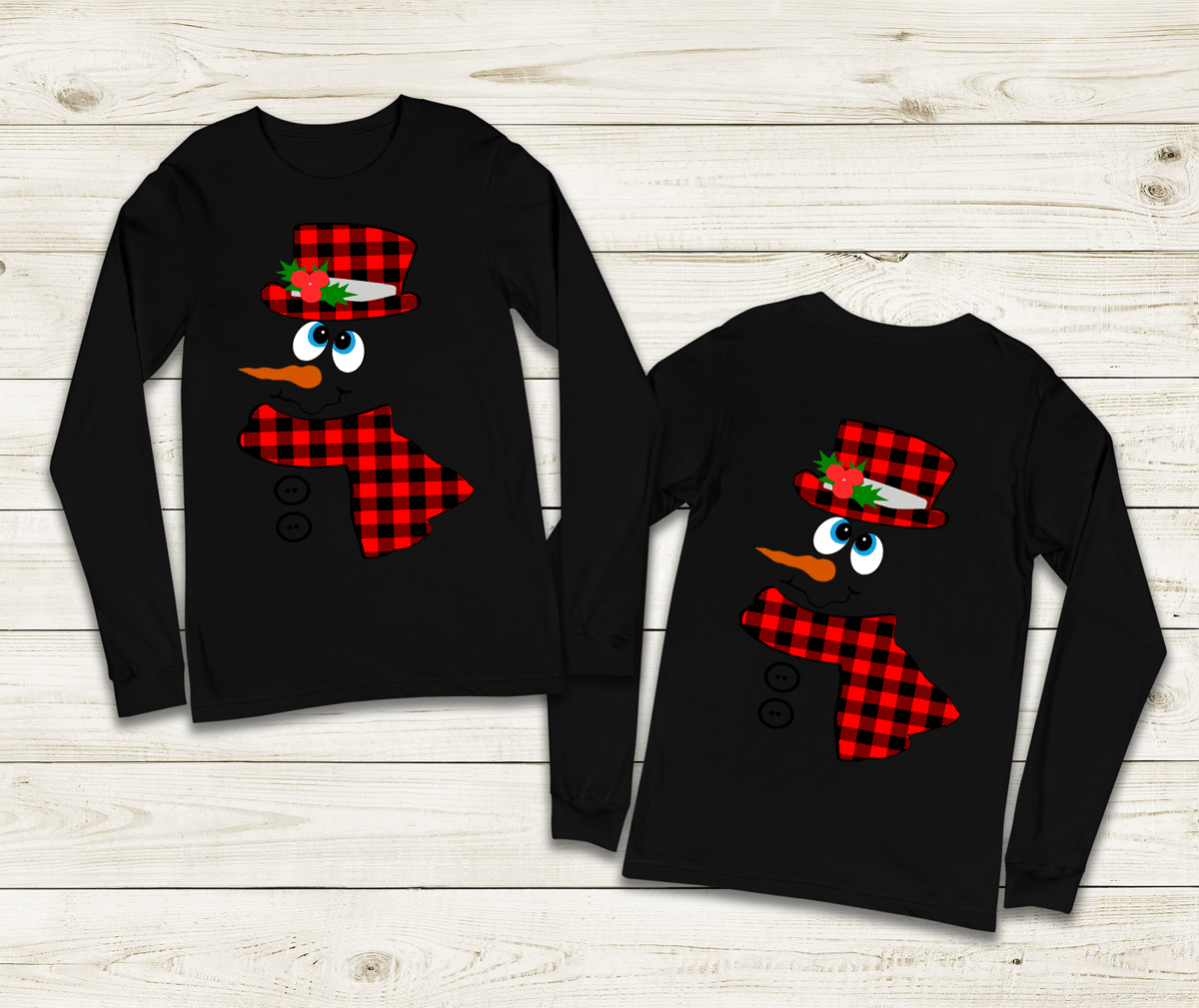 Two black long-sleeve shirts with snowman designs on a wooden surface