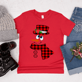 Red t-shirt with a snowman design surrounded by winter accessories on a light background