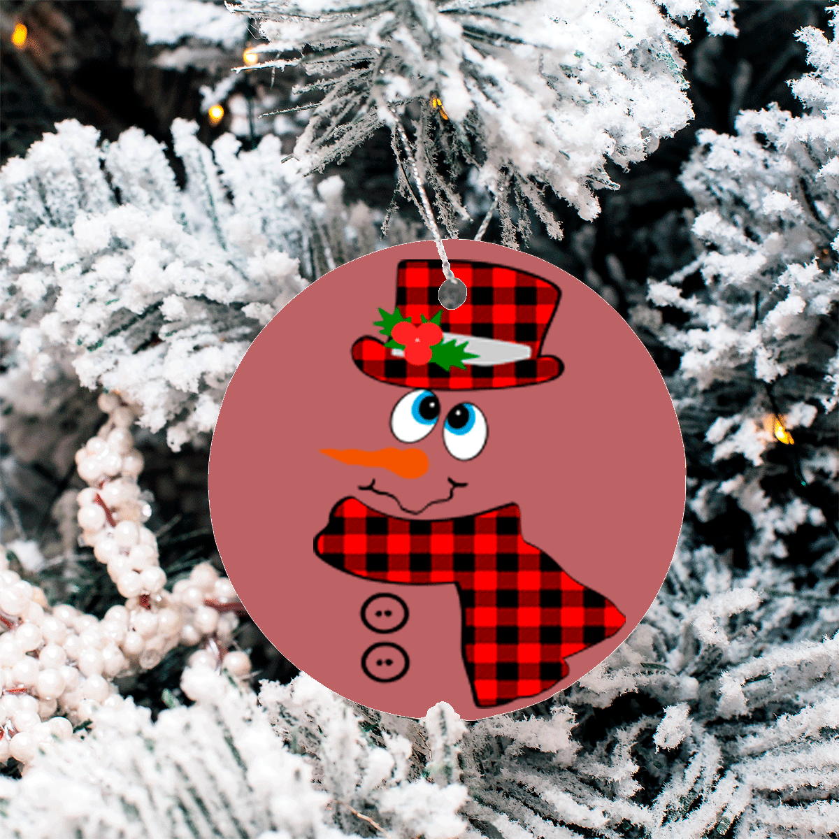 Round Christmas ornament with a snowman design on a tree