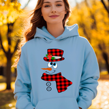 Person wearing a light blue hoodie with a snowman design in an autumn setting