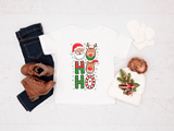 Christmas-themed shirt with reindeer and Santa Claus design, paired with jeans and boots on a white background.