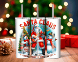 Three Christmas-themed tumblers with Santa Claus and snowman designs on a blurred festive background.