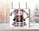 Tumbler with Santa Claus design and text on a wooden surface with a blurred background